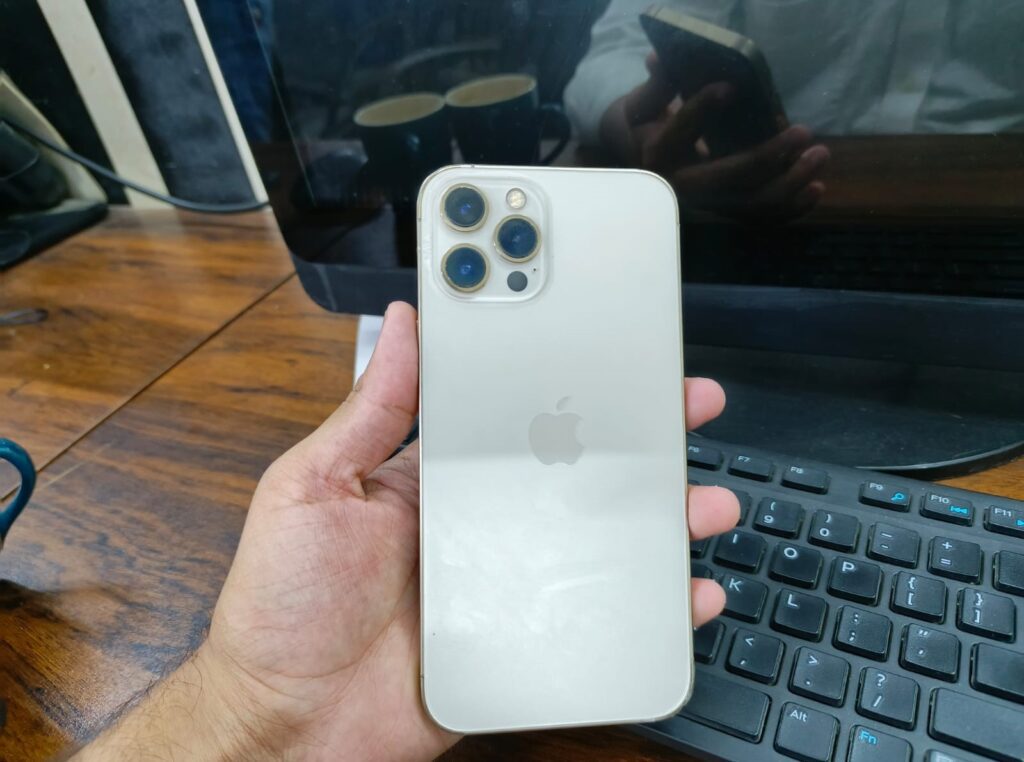 Back view of iPhone 12 Pro Max showing triple camera setup and matte glass finish