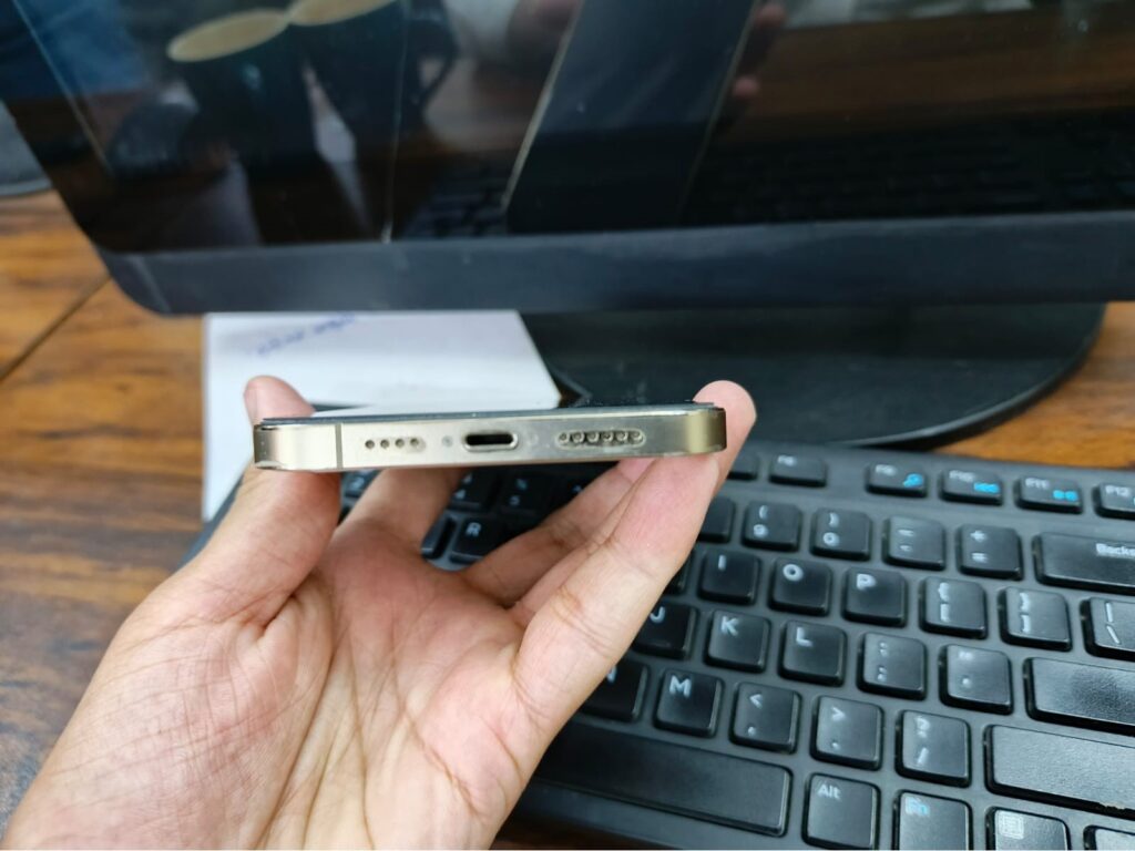 Bottom view of iPhone 12 Pro Max showing speaker grills and Lightning port.